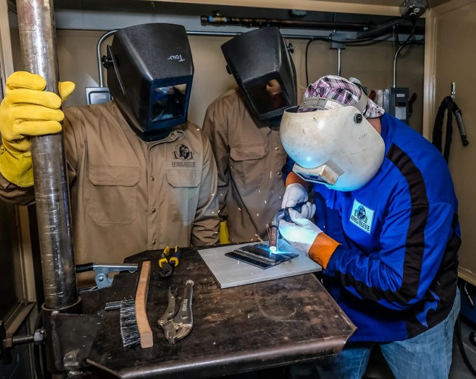 3 people welding