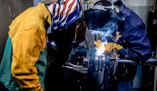 two people welding